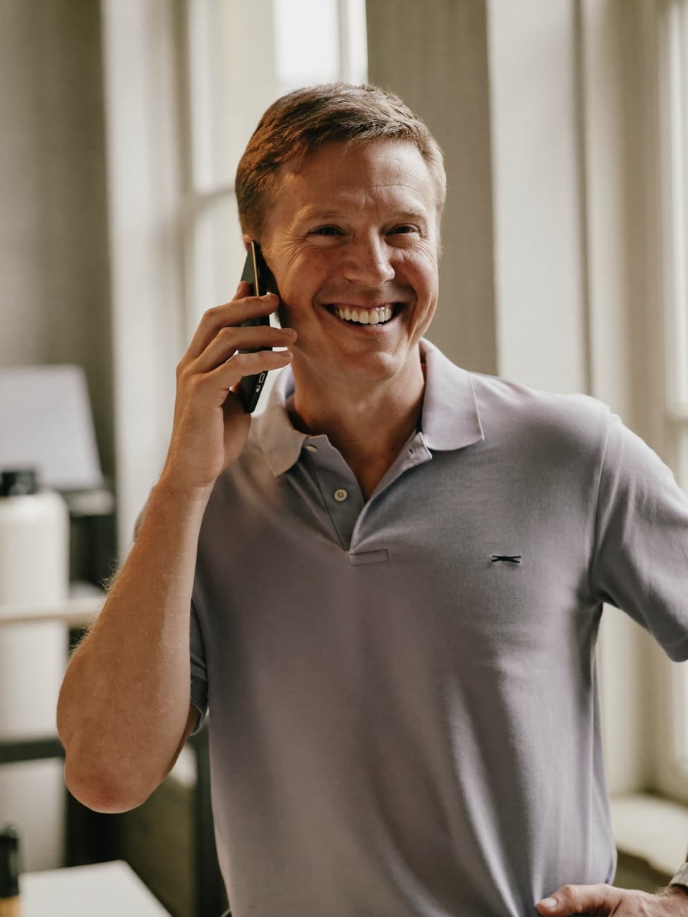 Local business owner answering the phone with a relaxed smile